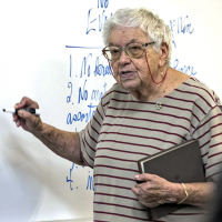 Photo of distinguished professor emerita of biology Lee Ehrman at the whiteboard