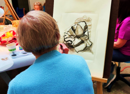 Woman artist with pencil drawing at art school