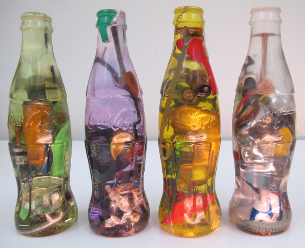 Image: Luis Perelman, Coca Cola Series, 1998, 21 parts; found materials embedded in clear resin, 7 ½ x 2 ¼ x 2 ¼, Co...