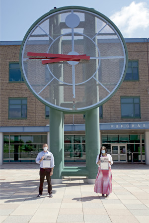 Interim President Dennis Craig and Chief Diversity Officer Jerima DeWese stand below the large clock on campus.