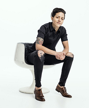 Marissa LaRocca '09 sits in a white chair with a white background