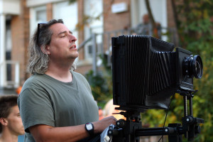 Photographer Gregory Crewdson '85 setting up a shot with his 8x10 camera on location in Pittsfield, Massachusetts at the corner of Seymo...