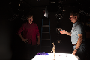 David Grill '86 and student look at stage model