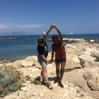 Students dancing on rocks, Antibes, France