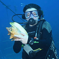 Student holding conch