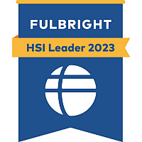 Blue badge with yellow stripe and white globe, reads Fulbright HSI Leader 2023