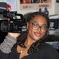 Meet the Editors: Elianna Forde student smilling and holding camera