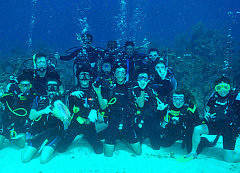 Group of students scuba diving and posing