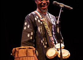 Yewhe Yeton Beninese artist with this instruments smiling