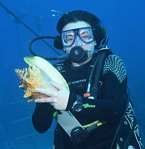 Student holding conch