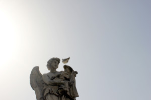 Statue in Italy with flag and sun