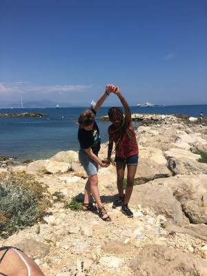 Students dancing on rocks, Antibes, France