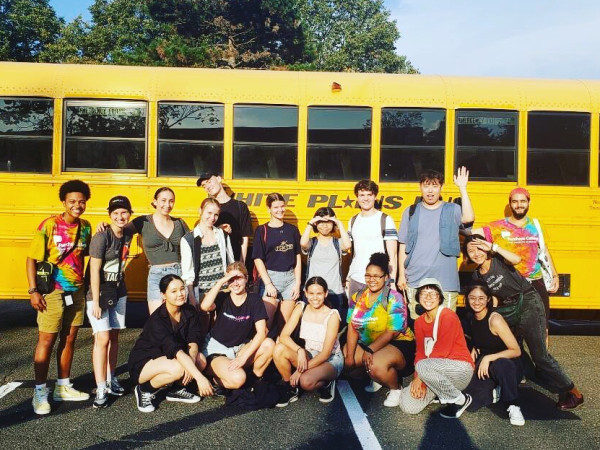 International Students and Global Ambassadors in front of yellow bus