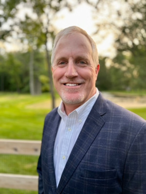 Man with suit jacket standing outside