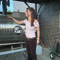 Compost Master Samantha standing next to the Rocket explaining how it works.
