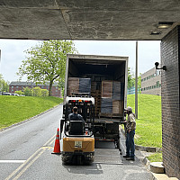 Furniture is loaded onto the back of a truck