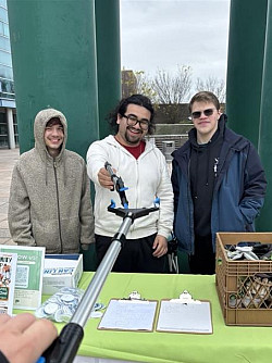 NYPIRGTableCampusCleanUp Students with trash grabbers for Earth Day Campus Clean Up.