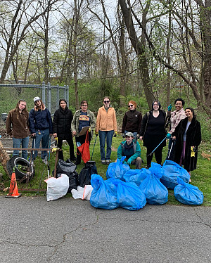 Students posing with blue and black garbage bags