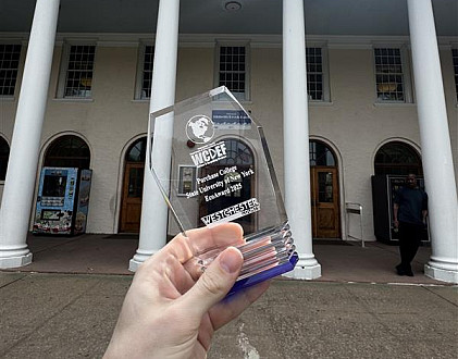Holding EcoAward plaque gifted to Purchase College