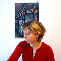 Loretta wearing a red top, facing left