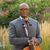 Earnest Lamb holding a cello