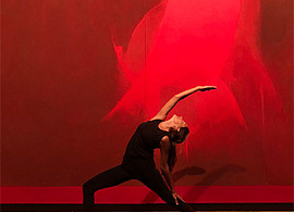 Female yoga instructor leading a stretch in the Neuberger Museum of Art