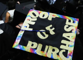 Photo from the 2023 Commencement with Proof of Purchase written in sparkling gold letters on the mortarboard