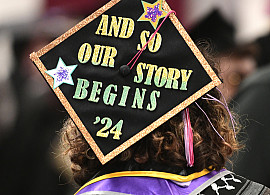 Photo from Commencement 2024 with a message on the mortarboard: And so our story begins '24