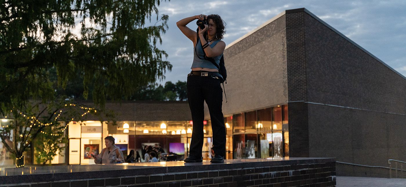 Student takes a photo at dusk.