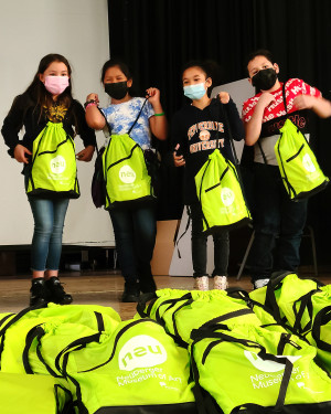 Distribution of NEU Kids Packs to local schoolkids at the Enrico Firmi School in Yonkers, NY.