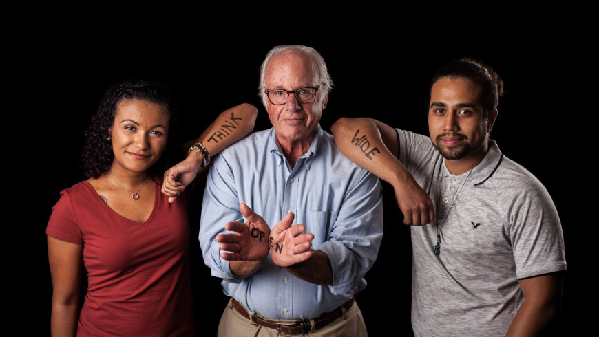 President Thomas J. Schwarz with two students and the Think Wide Open slogan