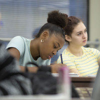 A student writing on her paper