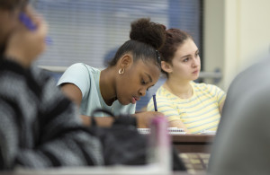 A student writing on her paper