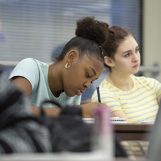 A student writing on her paper