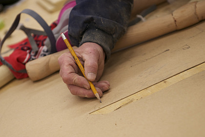 Hand draws plans on table