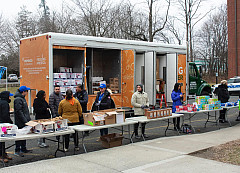 Truck from Feeding Westchester with tables set up with food donations