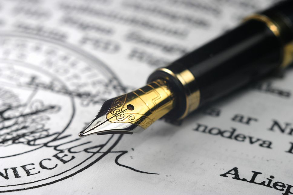    Golden pen on a document 