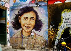 portrait of Anne Frank on wall.
