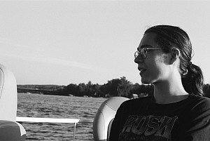 Alec Hawkins sitting on a boat.