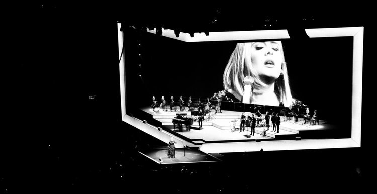 Katie Kresek ?98, ?99 on stage with Adele at LA's Staples Center in 2016