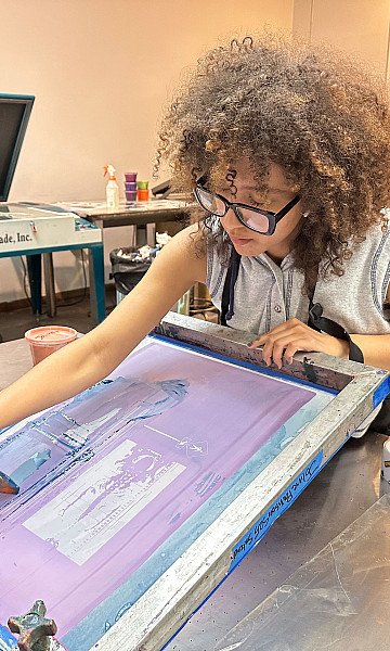 Student working on a screen print