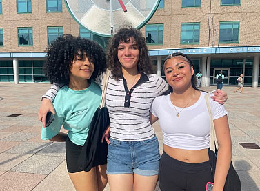 Group of Purchase College students smiling together on campus.