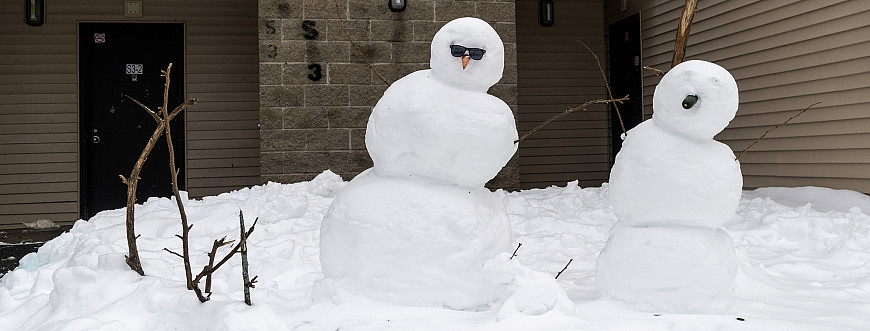 Snowpeople near residence entrance
