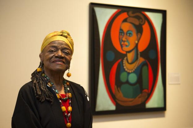    Faith Ringgold with self-portrait in American People, Black Light: Faith Ringgold's Paintings of the 1960s at the National Museum of W...