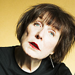 Color photograph of a woman with her head tilted to one side