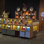 Display cases filled with art objects, catalogues, and other items for sale in the The Neuberger Museum Store