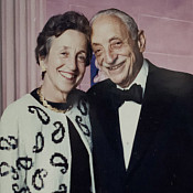 Lynn and Phil Straus against a pink background