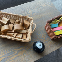 Wooden blocks. Magnetic blocks that are faded pink, blue, green and orange. Magic 8 ball.