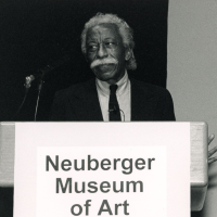 Gordon Parks at a podium with the words Neuberger Museum of Art