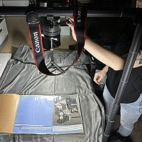    The archivist photographing scrapbooks from the Roy R. Neuberger Papers.  